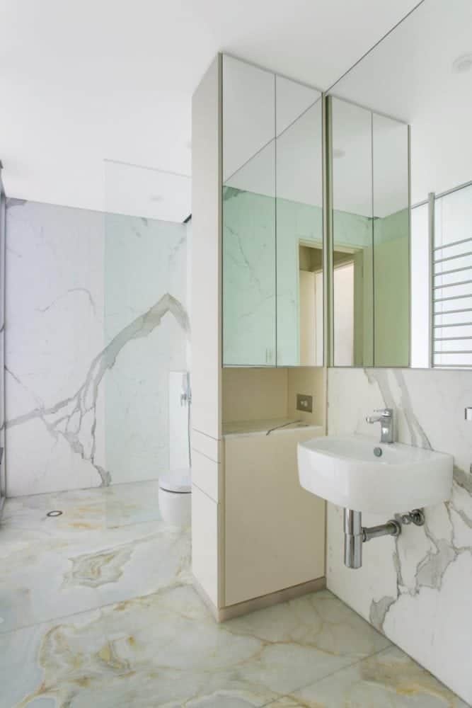 calacatta marble ensuite walls and white onyx floor