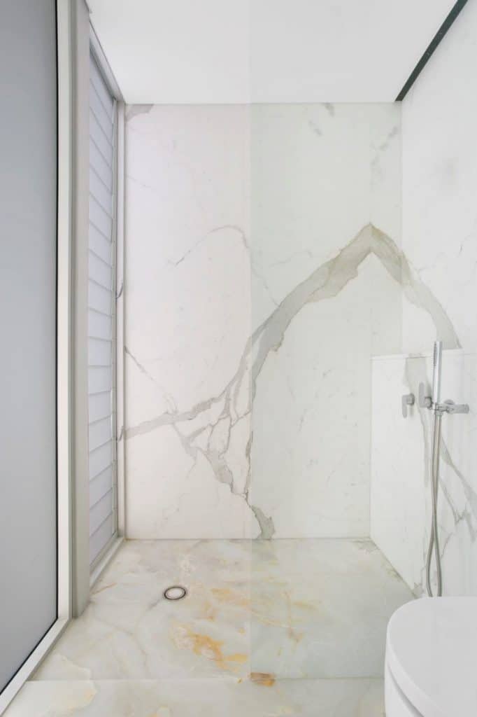 calacatta marble wall cladding and white onyx floor