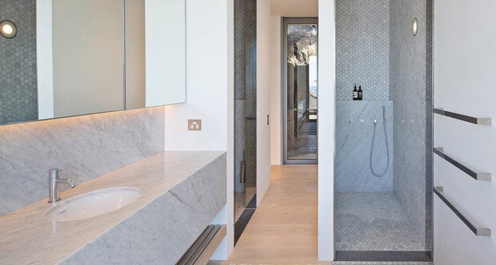 carrara marble vanity and shower walls